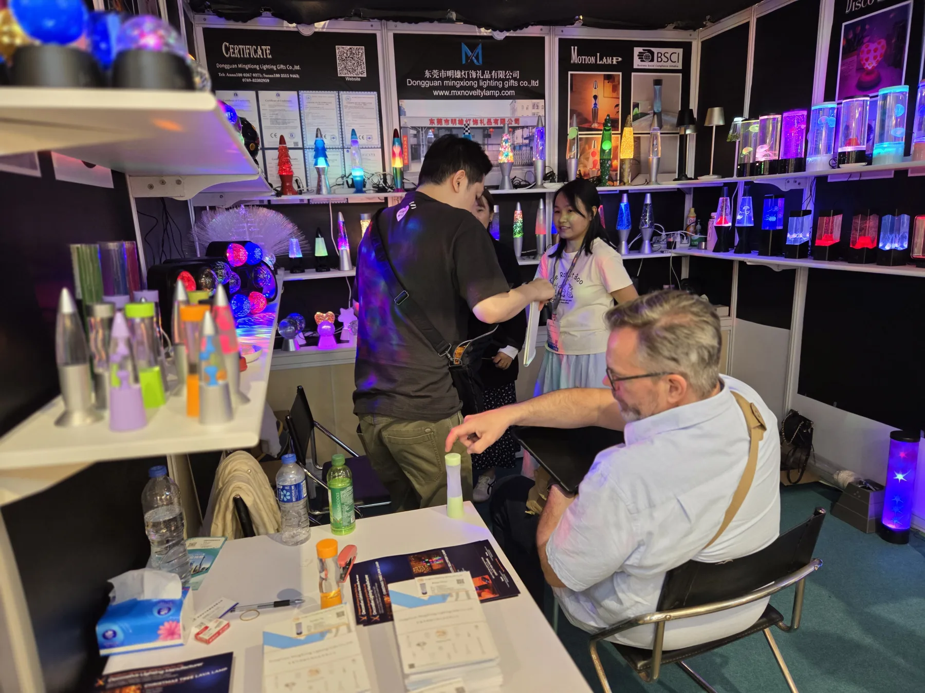 Mingxiong Lighting team presenting decorative lamps to buyers in Hong Kong
